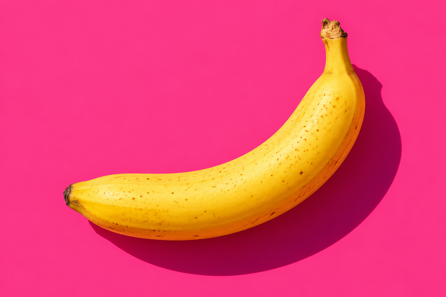 Yellow banana on a pink background